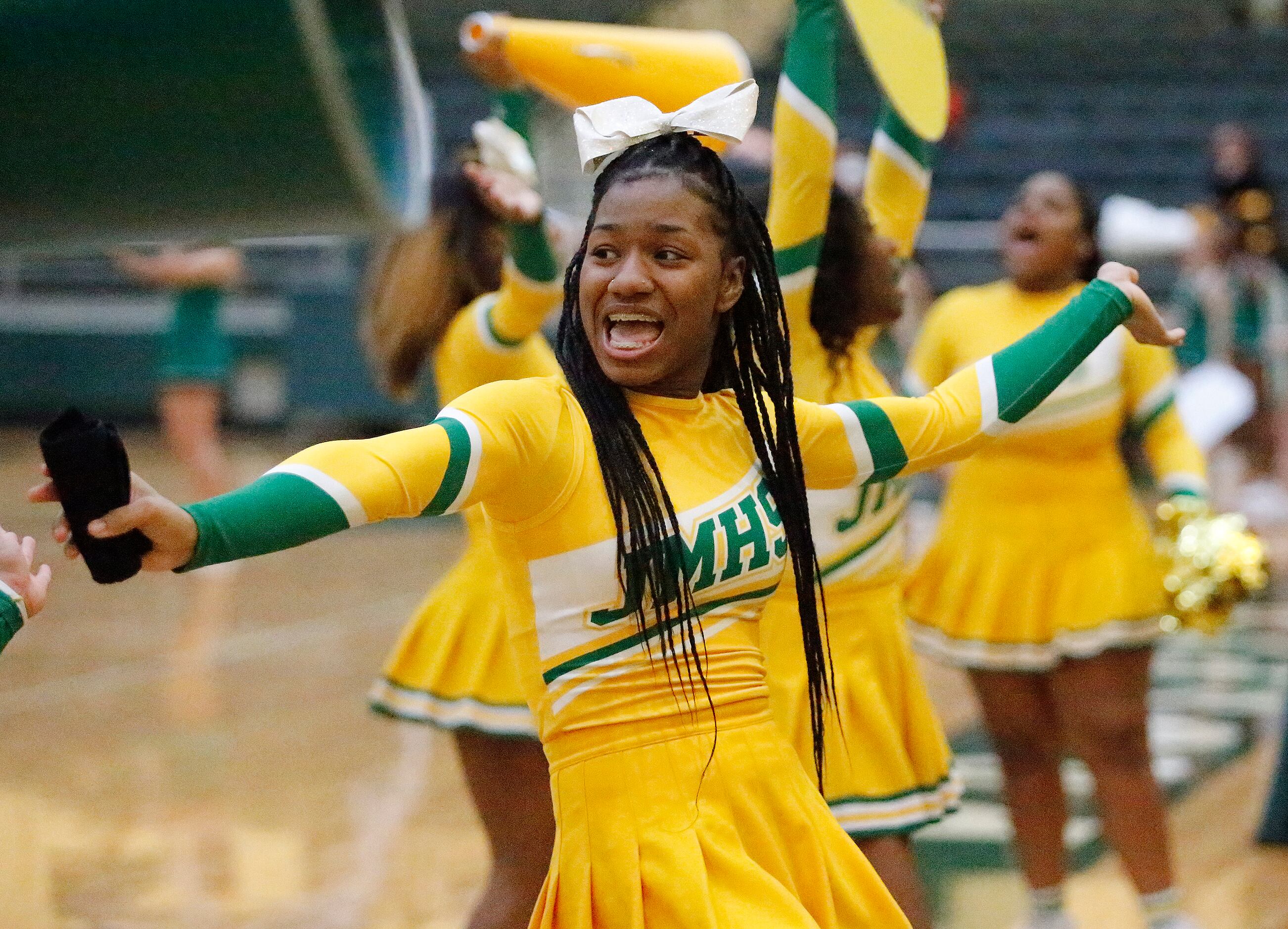 Madison cheerleader Jamesia Newhouse, 17, cheers her team on during the second half of the...