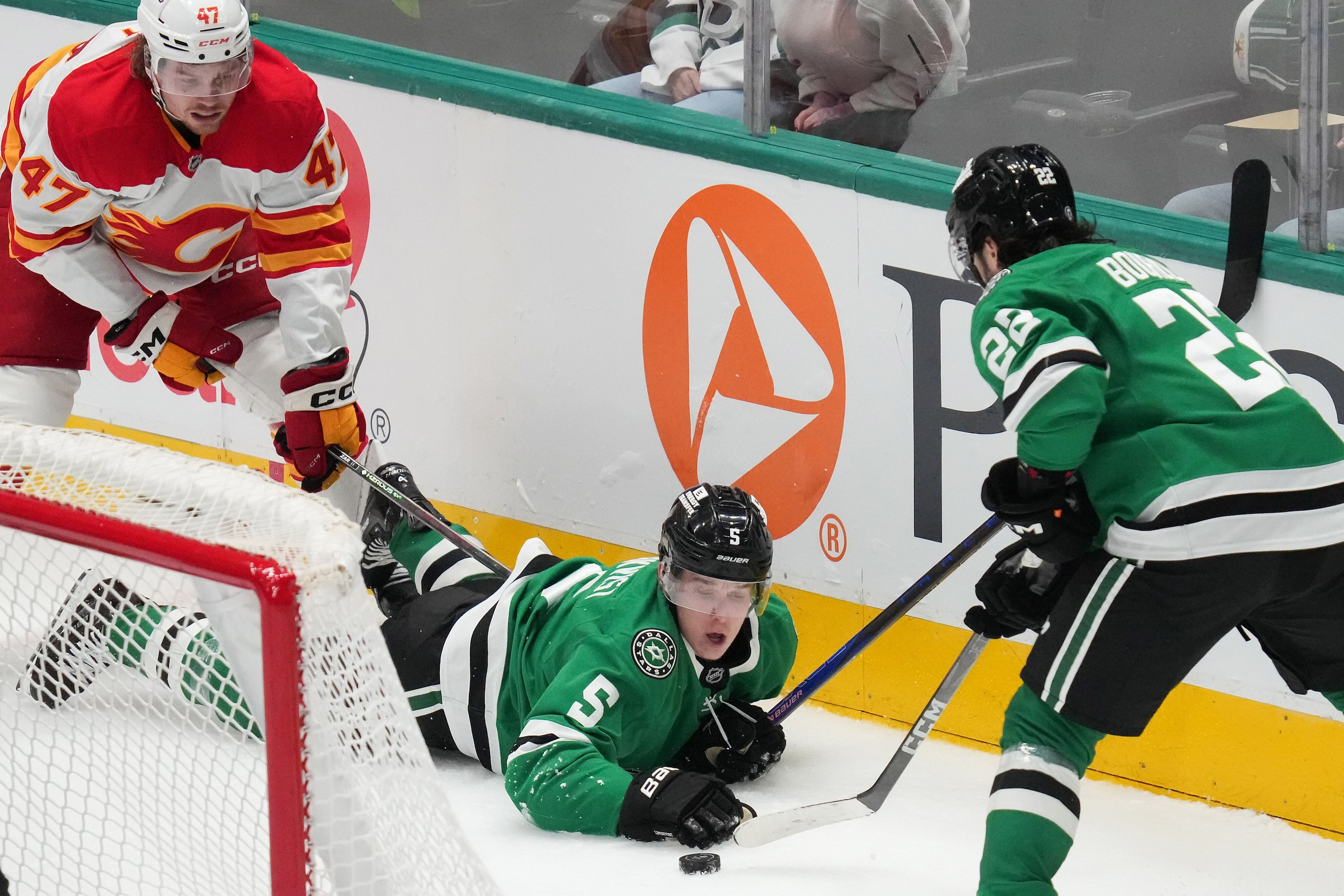 Dallas Stars defenseman Nils Lundkvist (5) pushes a puck behine the net between center...