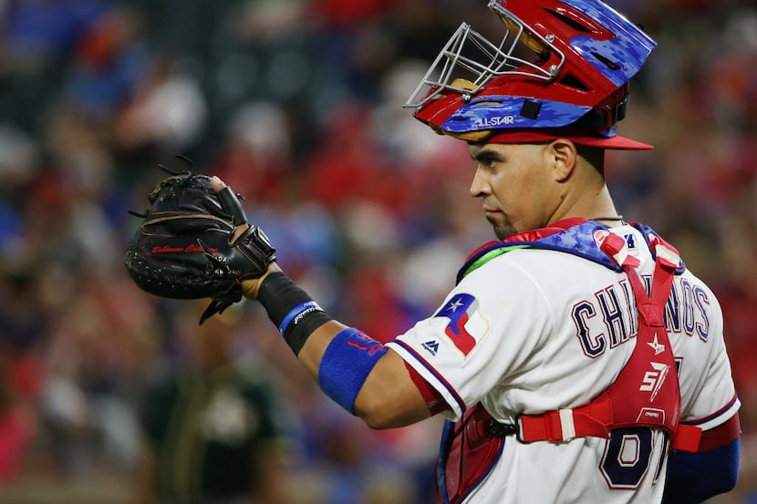 Texas Rangers catcher Robinson Chirinos (61) looks toward the mound during a Major League...