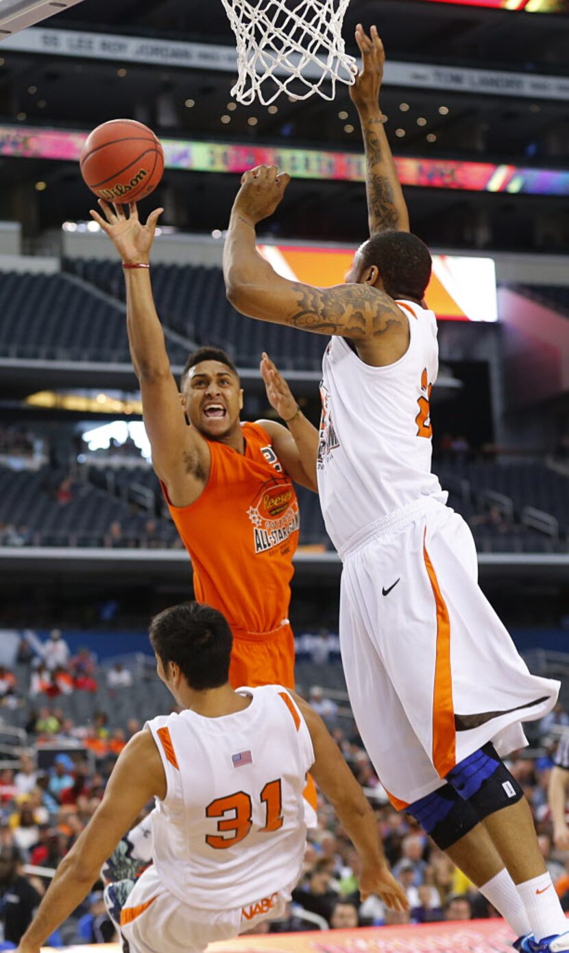 East forward Jarrelle Benimon (22) of Townson puts up a shot between West defenders...