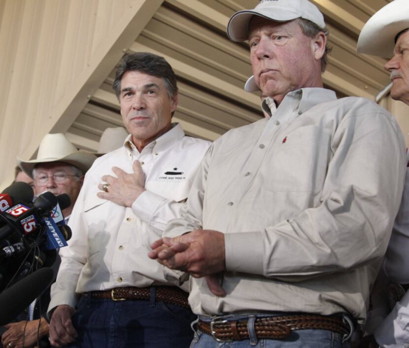 Gov. Rick Perry, with West Mayor Tommy Muska earlier this year, says more spending on...