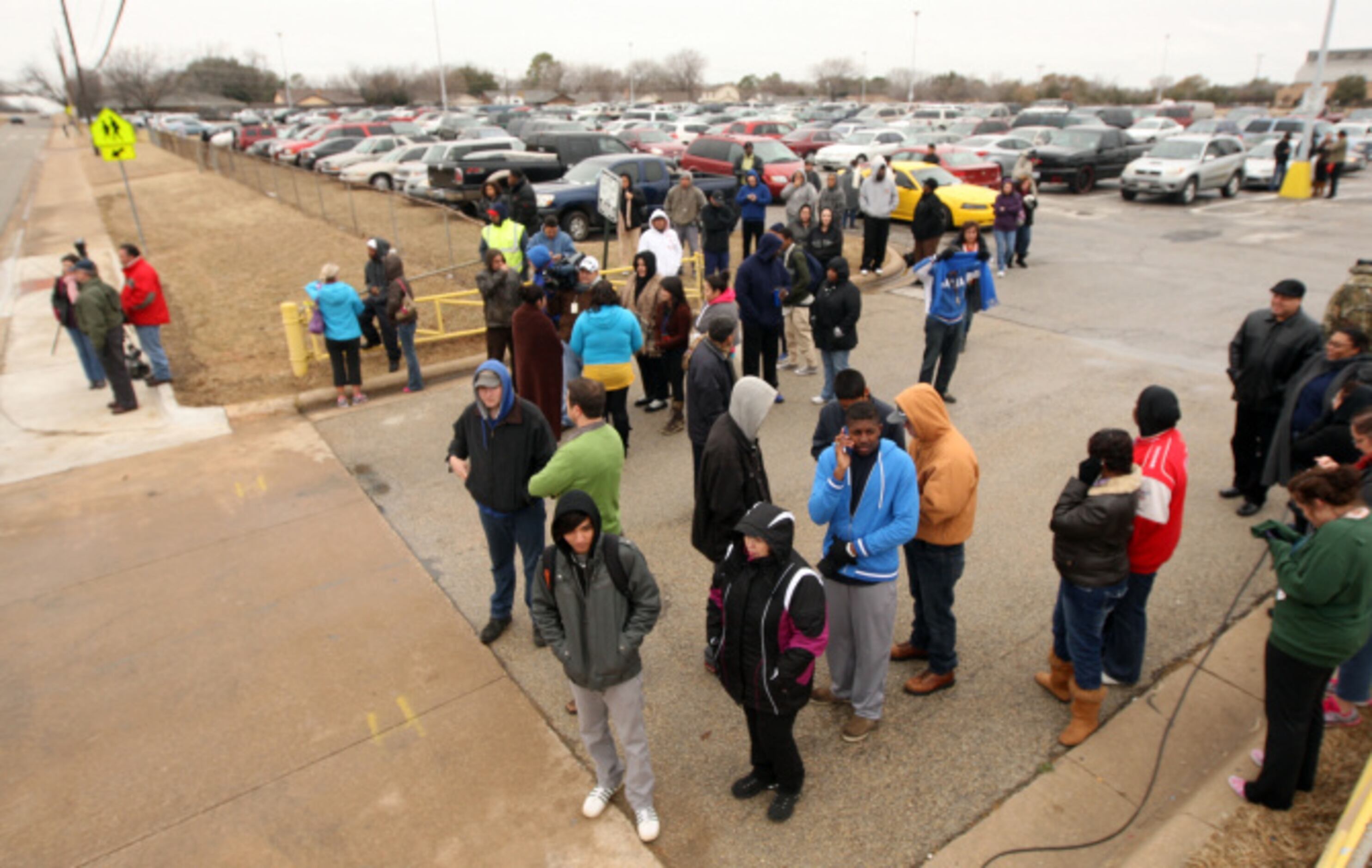 Parent wait for news during a lockdown at Arlington Lamar High School due to a report of a...