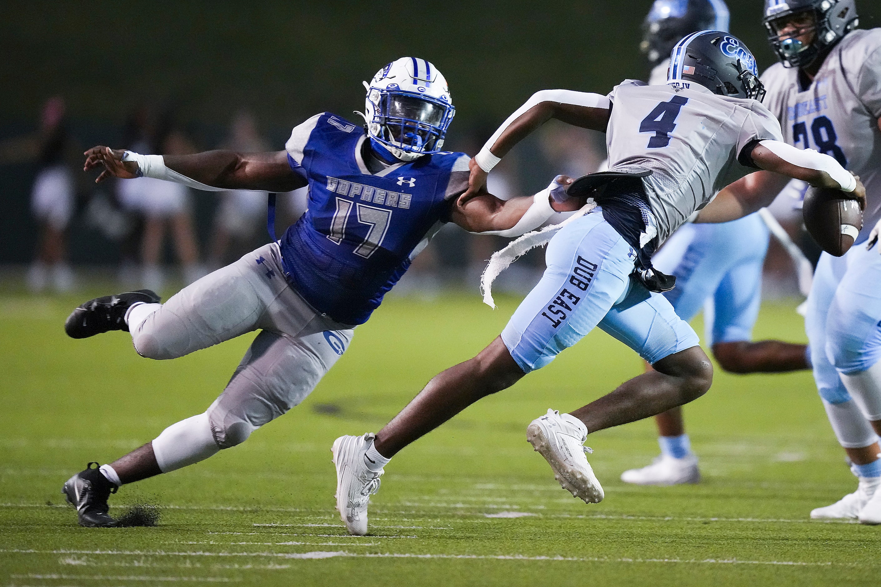 Wylie East quarterback Howard Fisher IV (4) scrambles away from Grand Prairie defensive...