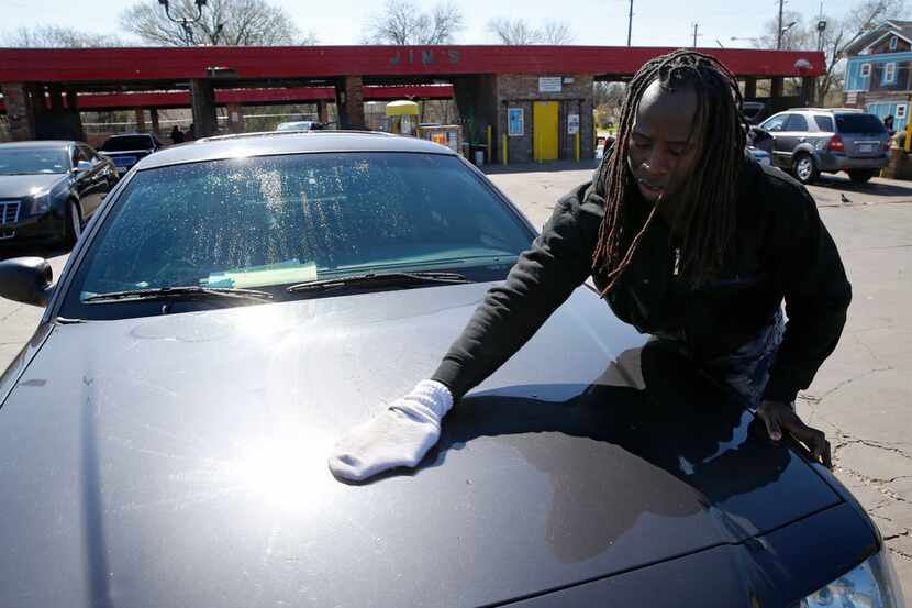 Tyrone Jackson dries his car at Jim's Car Wash on Martin Luther King Jr. Boulevard in Dallas. 