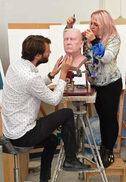 Principal Sculptor David Gardner, left, and Sophie Crudgington work on an an unfinished wax...