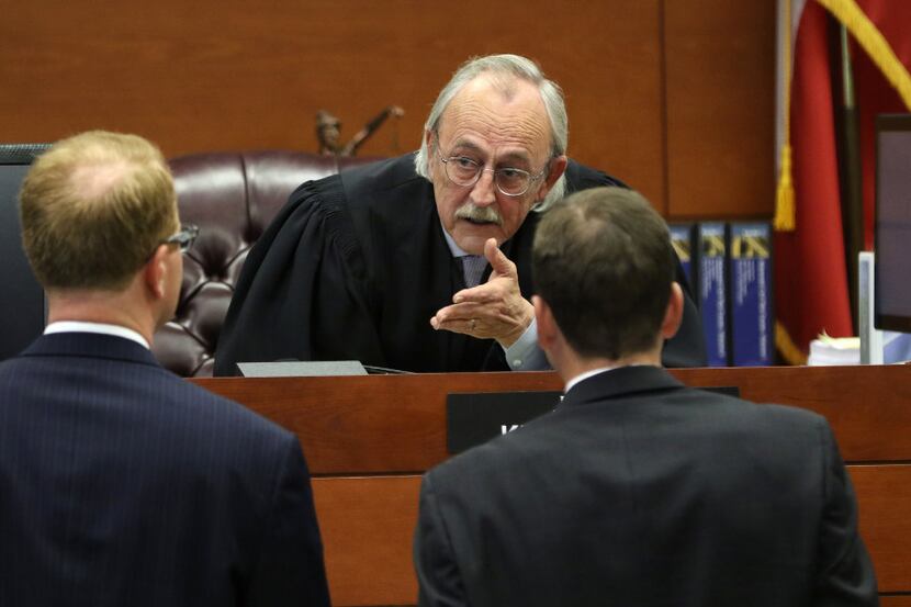 Judge Ken Molberg (center) listens to arguments during the temporary injunction hearing to...