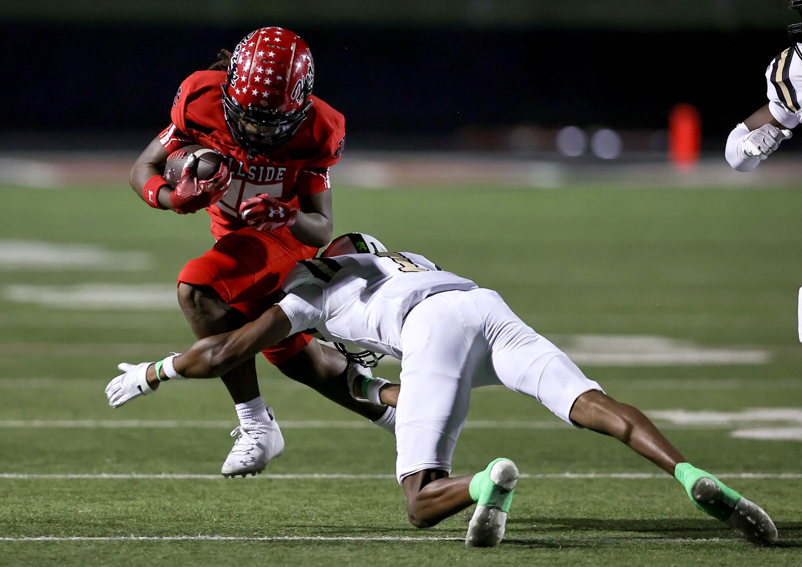 Cedar Hill running back Ashton Blake (26) tries to avoid Mansfield cornerback Chibu Ojirika...