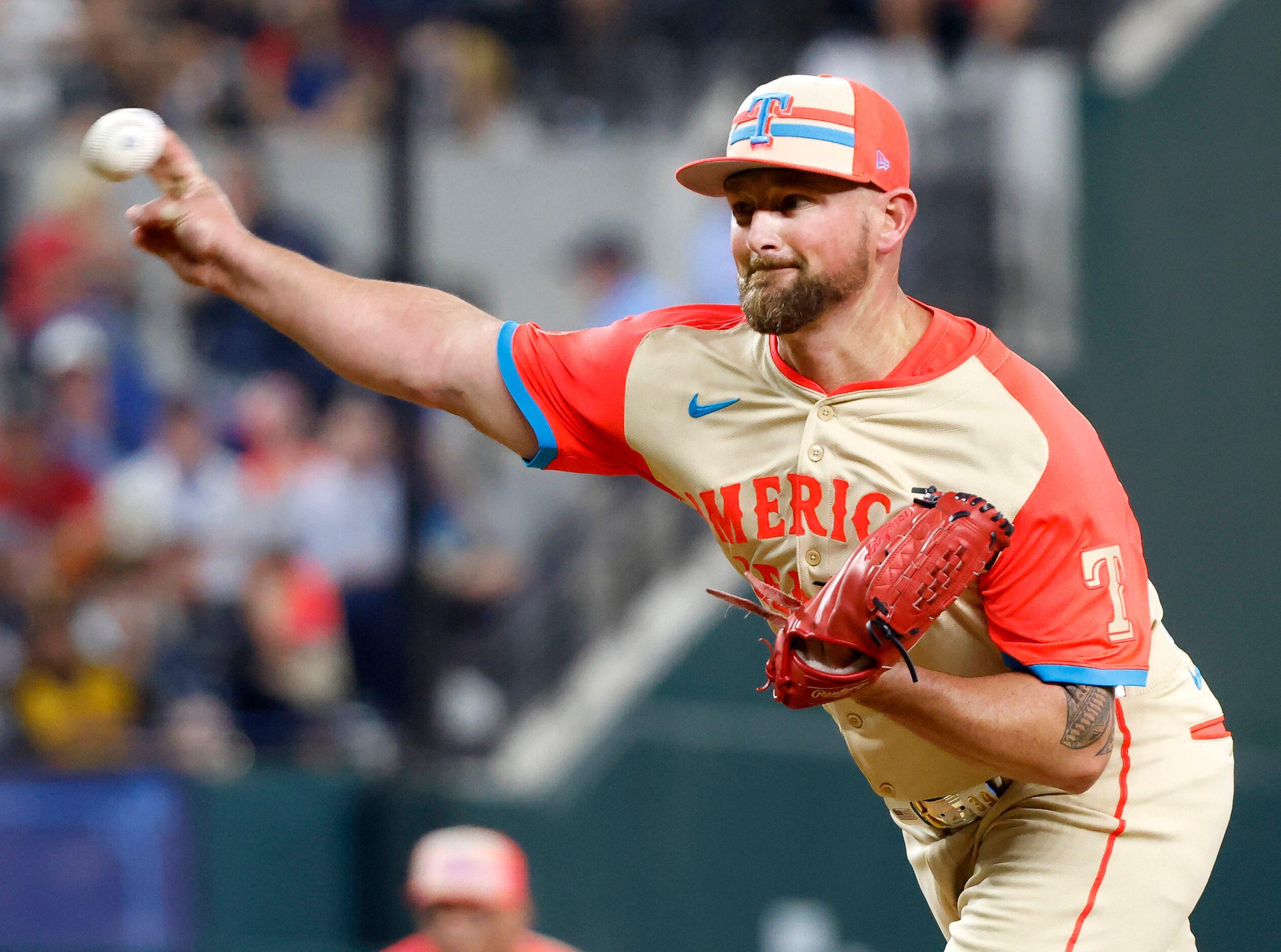 American League pitcher Kirby Yates, of the Texas Rangers, (right) throws to the National...