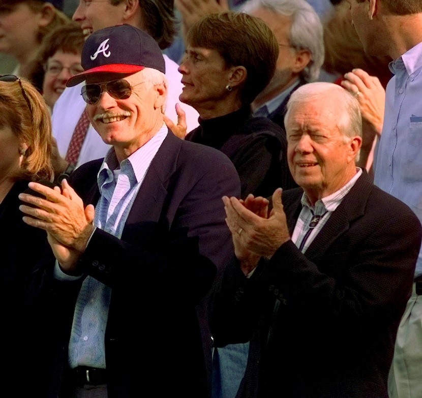 Jimmy Carter and Atlanta Braves team owner Ted Turner watch early play during Game 6 of the...