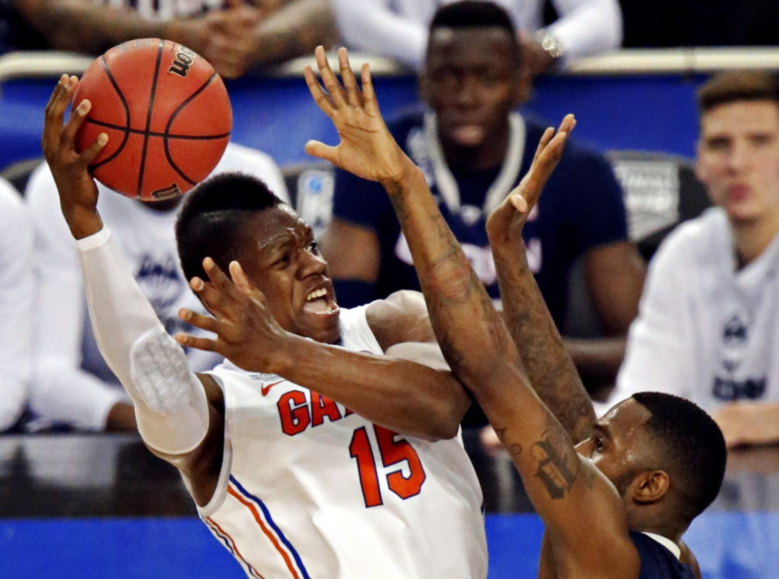 Connecticut Huskies forward Phillip Nolan (right) defends Florida Gators forward Will...