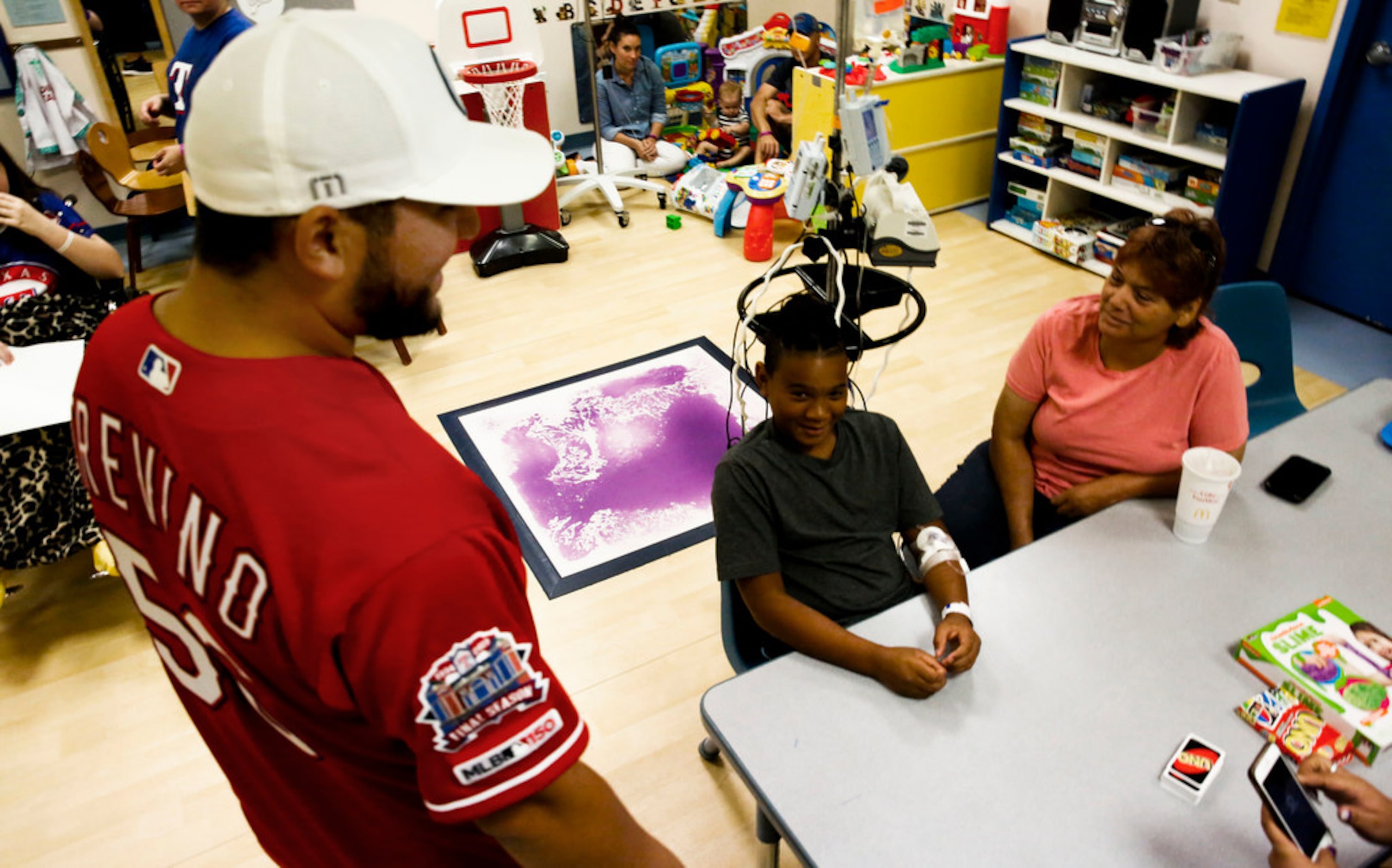 Texas Rangers catcher Jose Trevino talks with 11 year-old patient Jashawn Smith at Medical...