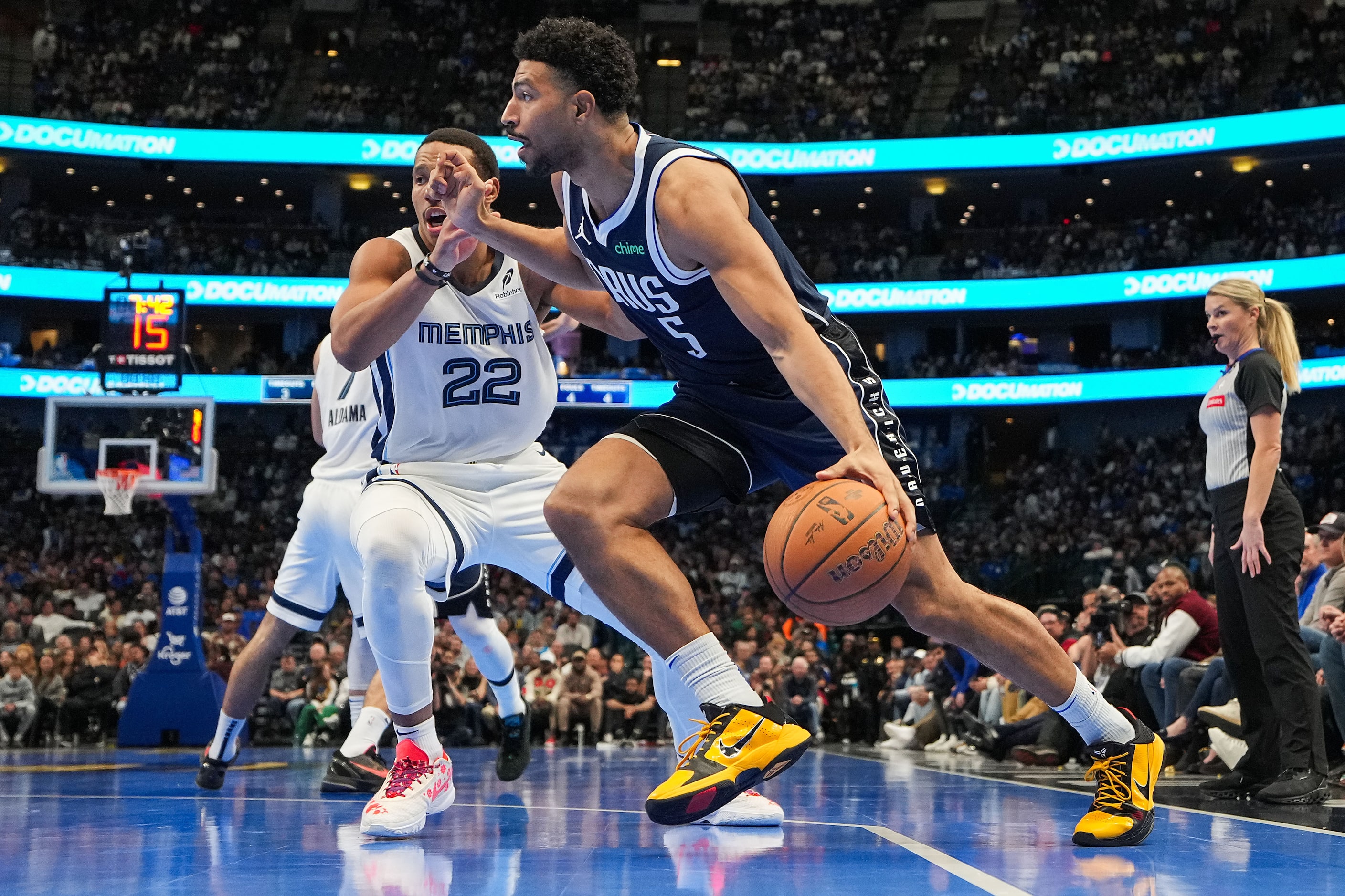 Dallas Mavericks guard Quentin Grimes (5) drives past Memphis Grizzlies guard Desmond Bane...