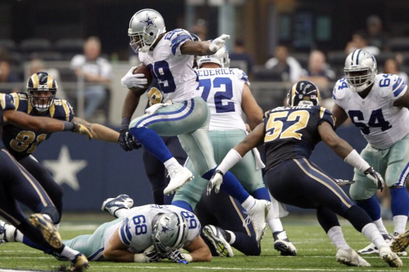 Dallas Cowboys running back DeMarco Murray (29) leaps over Dallas Cowboys tackle Doug Free...