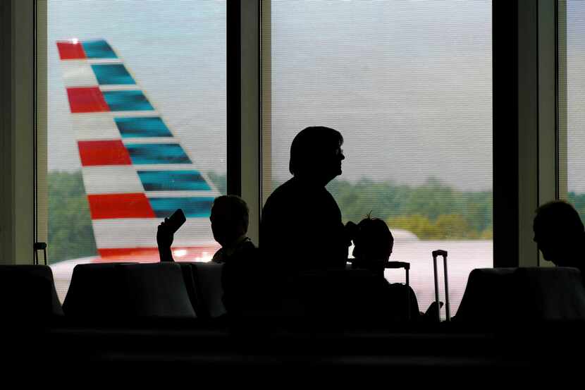 Passengers wait for an American Airlines flight at Raleigh Durham International Airport on...