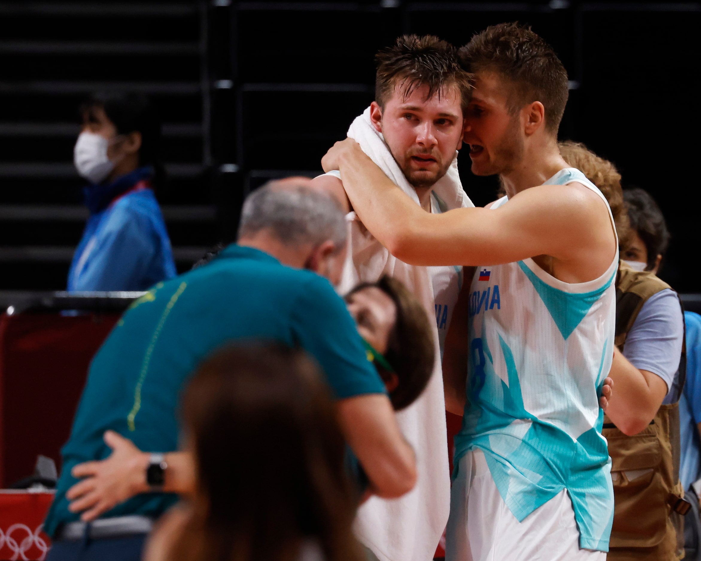 Slovenia’s Edo Muric (8) talks to Luka Doncic (77) as Australia’s team celebrates a victory...