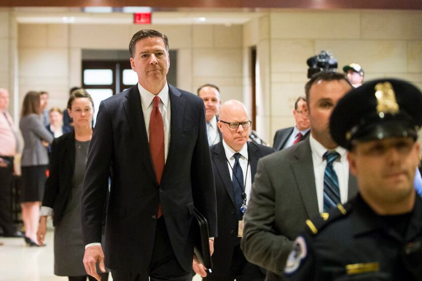 FBI Director James Comey walks to a briefing about the mass shooting in Orlando, Fla., at...
