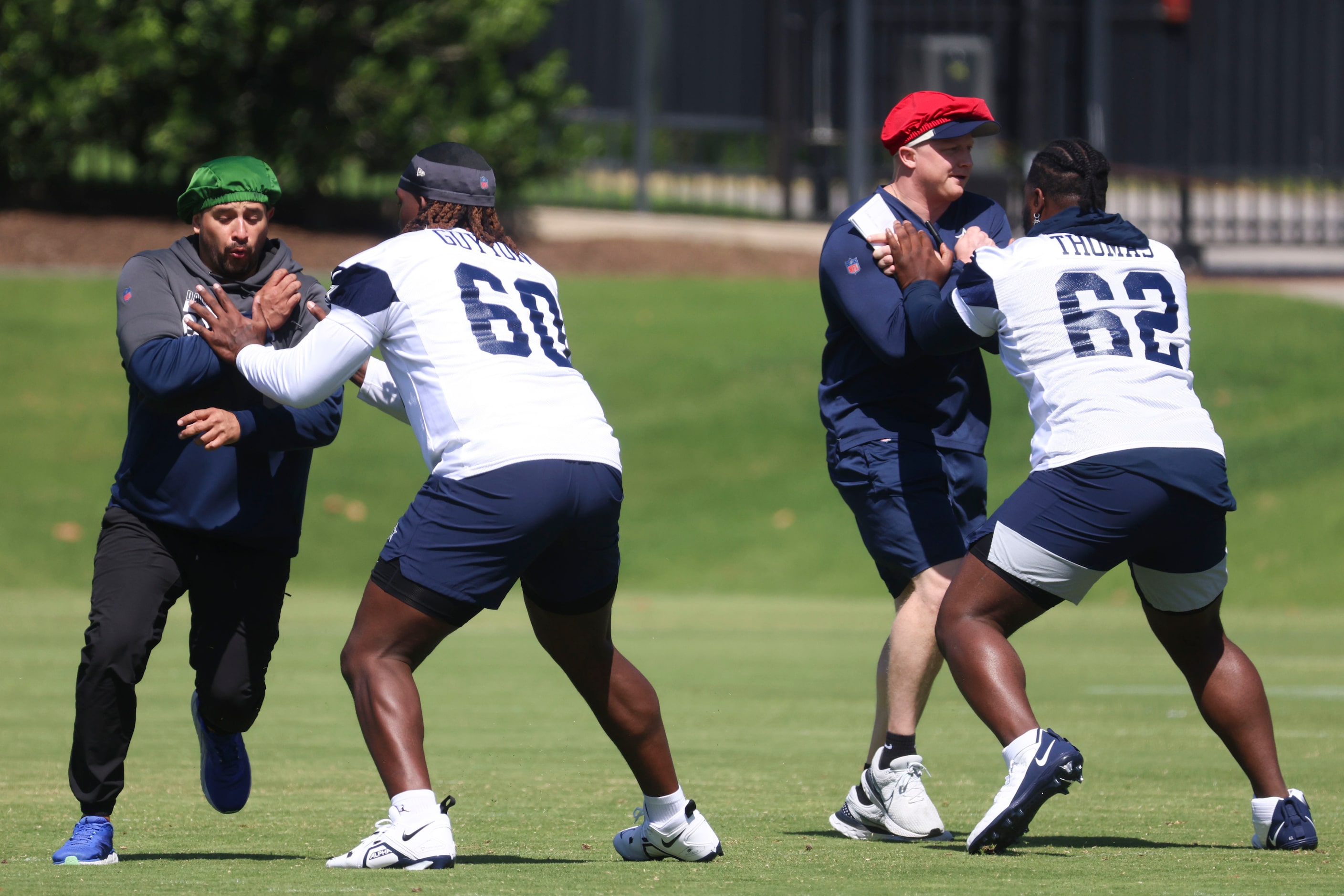 Dallas Cowboys offensive tackles Tyler Guyton (60) and Nathan Thomas (62) take part in a...