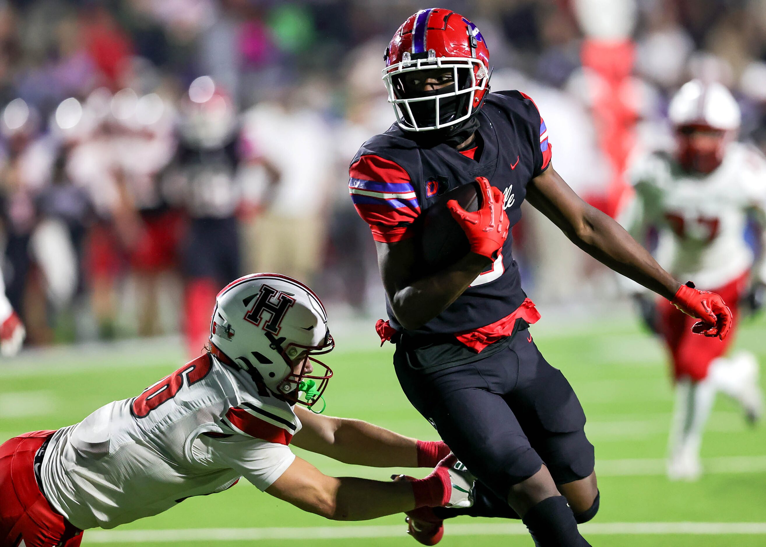 Duncanville wide receiver Zach Turner (right) gets past Rockwall Heath linebacker Brady Luff...