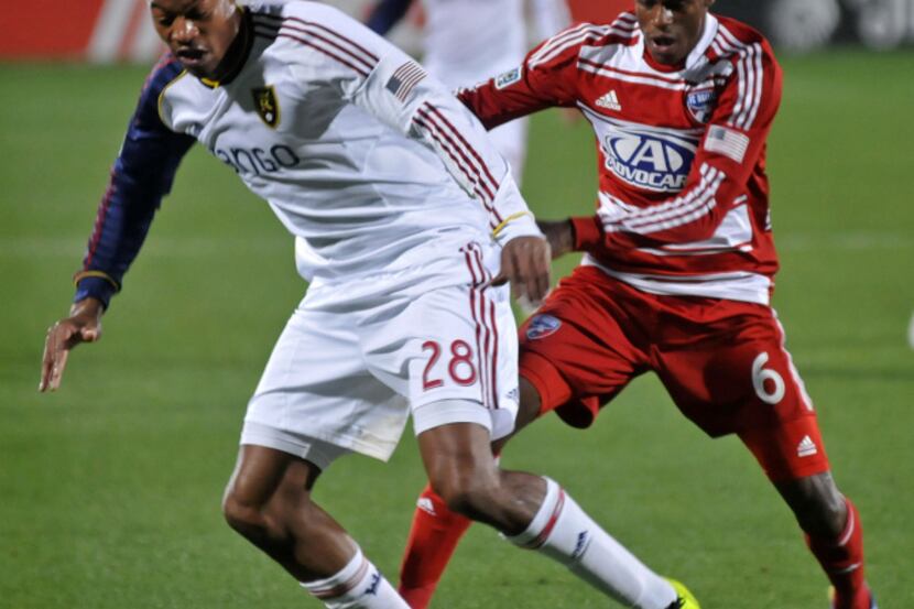 FC Dallas' Jackson (6) tries to work around Real Salt Lake's Chris Schuler (28) to get the...