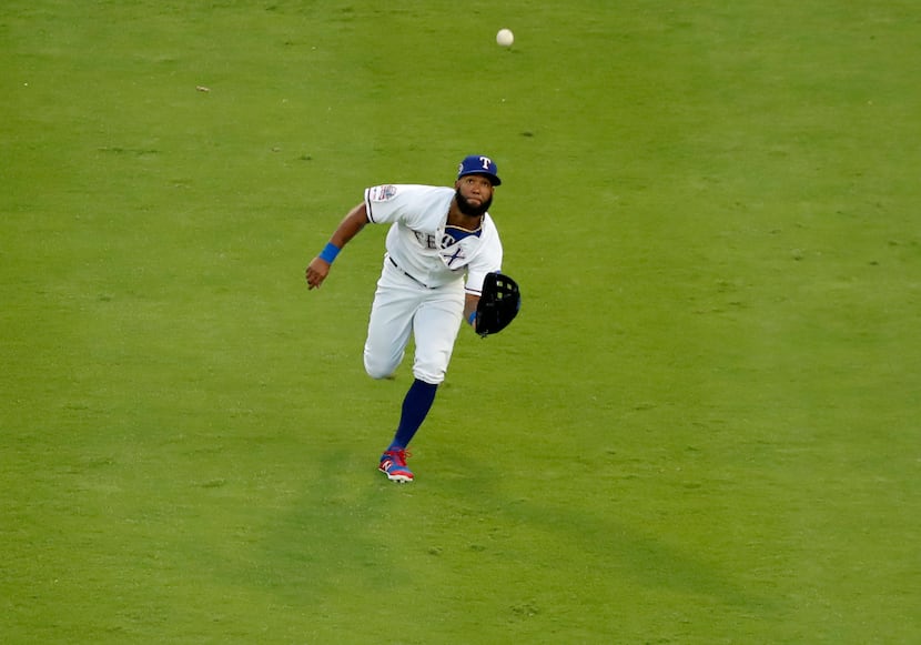 Texas Rangers center fielder Danny Santana reaches out to field a fly out by Tampa Bay Rays'...
