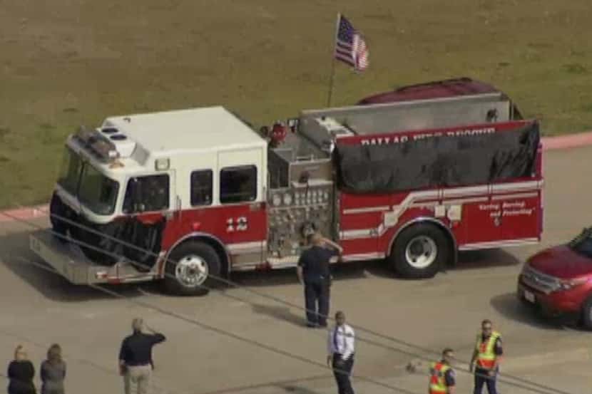 A Dallas Fire-Rescue truck carrying the casket of William Scott Tanksley leaves the...