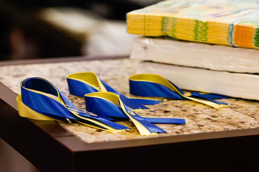 Ribbons with Ukraine flag colors rest at the checkout of Ukie Style Embroidery Art, a...