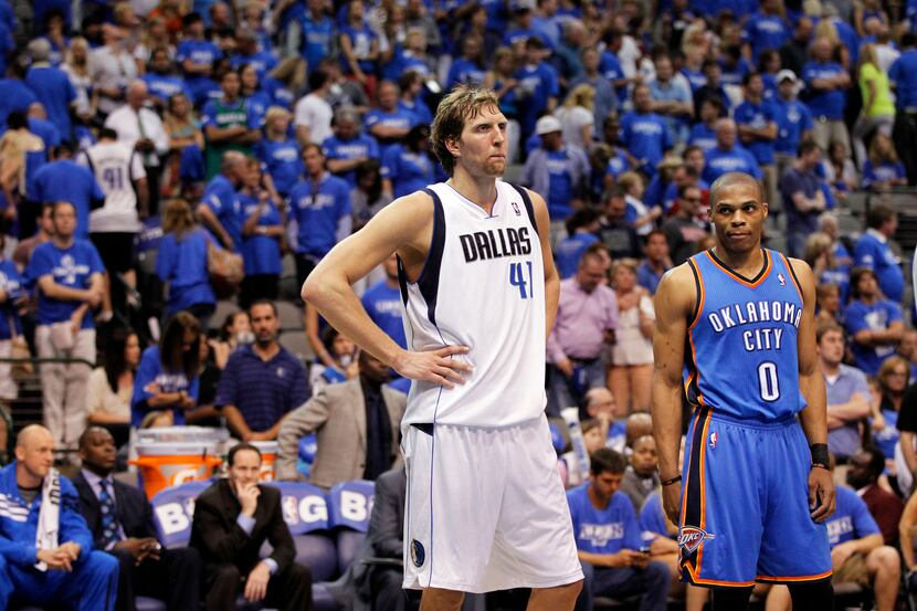 Oklahoma City's Russell Westbrook (right) looks at Dallas' Dirk Nowitzki late in the fourth...