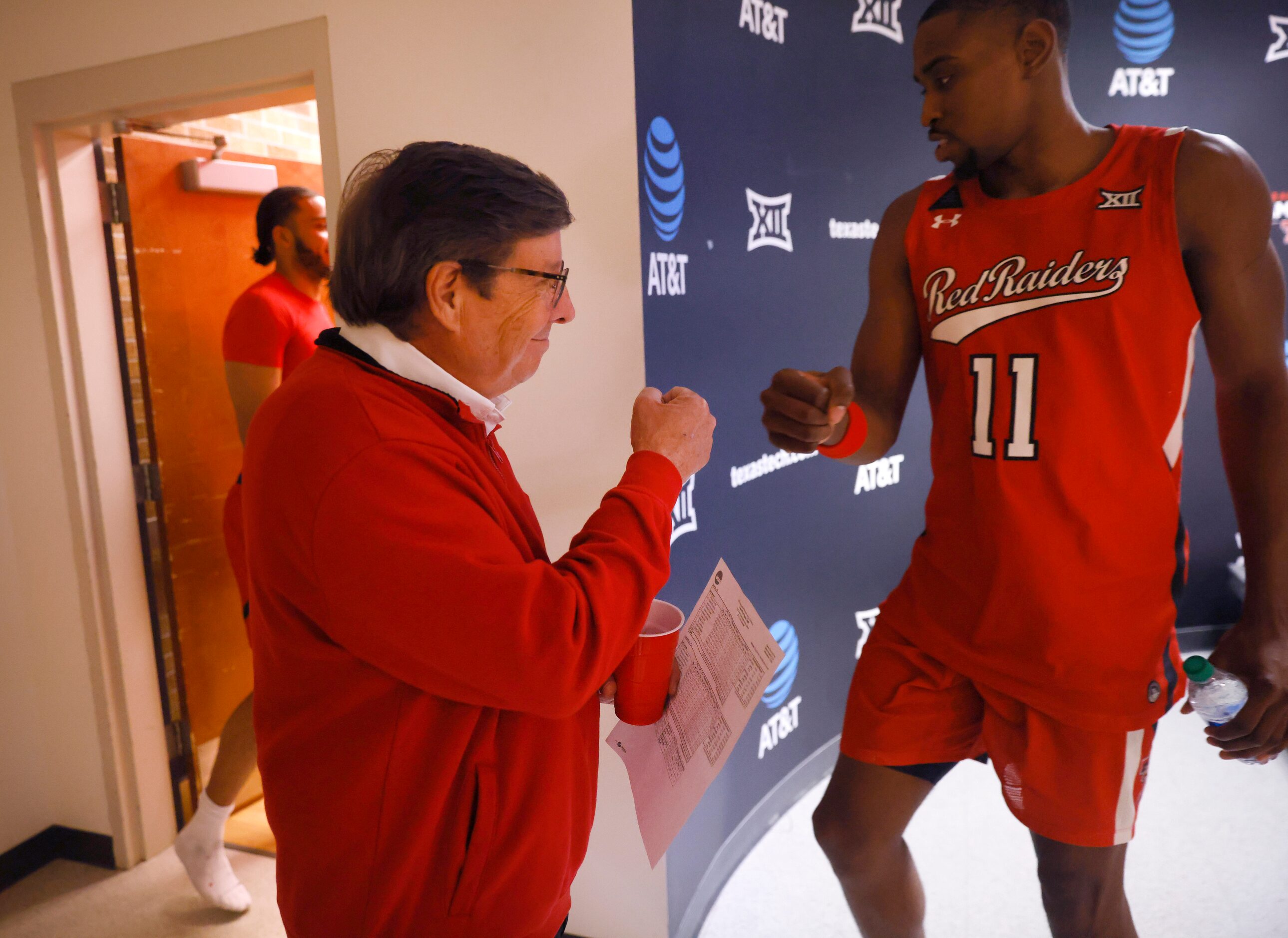 Texas Tech Red Raiders head coach Mark Adams (left) gives a fist bump to his forward Bryson...