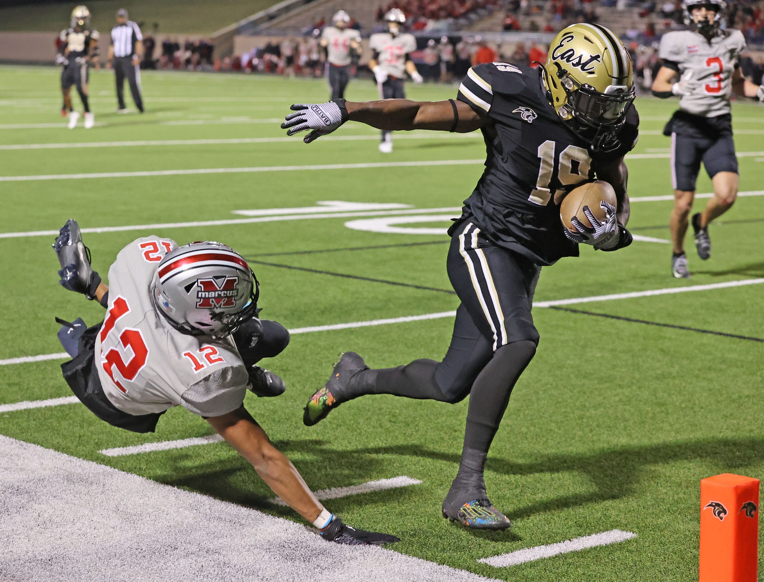 Plano East high WR Jaylon Hatcher (19) takes his reception past Flower Mound Marcus defender...