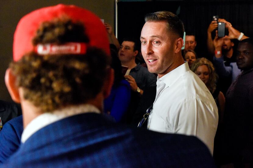 Texas Tech coach Kliff Kingsbury congratulates Patrick Mahomes, foreground, during an NFL...