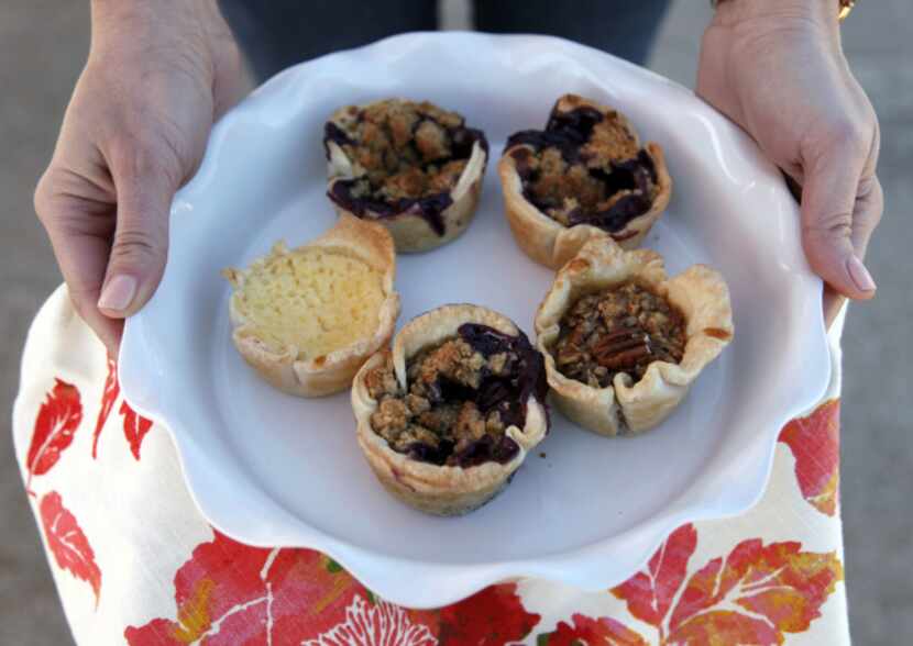 An assortment of Pie Flutin' Pastries mini pies, including blueberry crumble, black bottom...