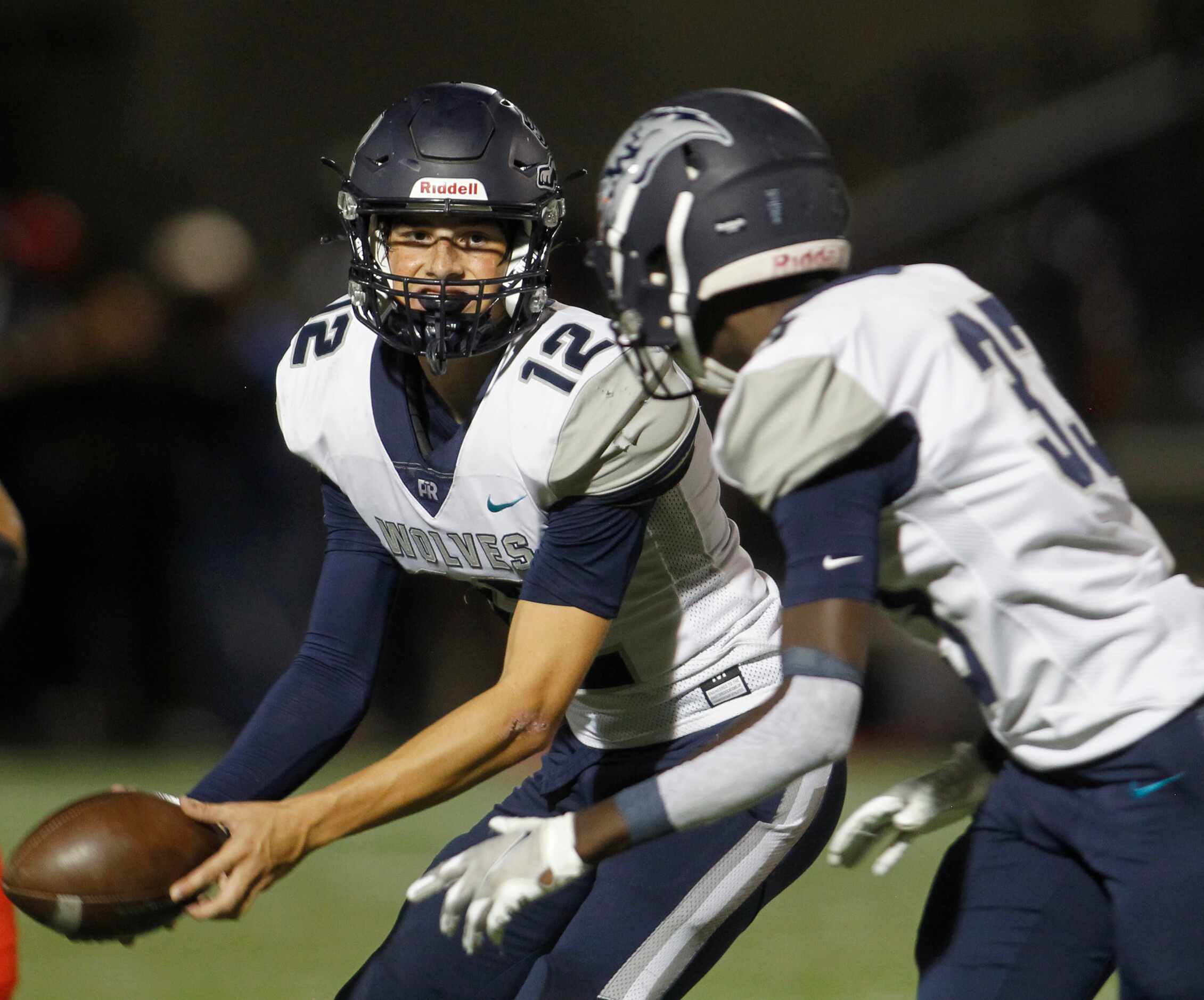 Carrollton Ranchview quarterback David Martini (12) pitches the ball to running back Michael...