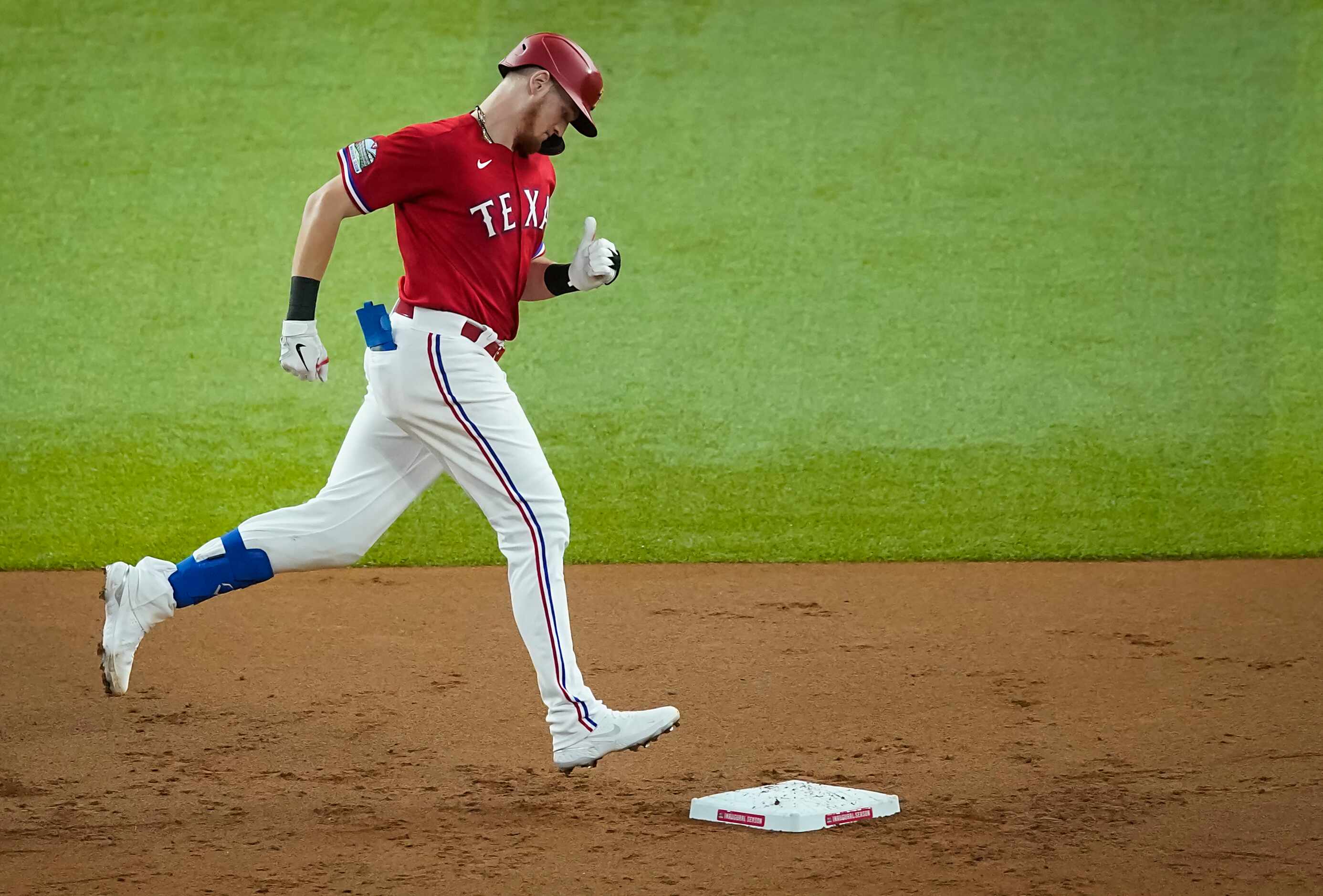 Texas Rangers catcher Sam Huff rounds the bases after hitting a solo home run during the...
