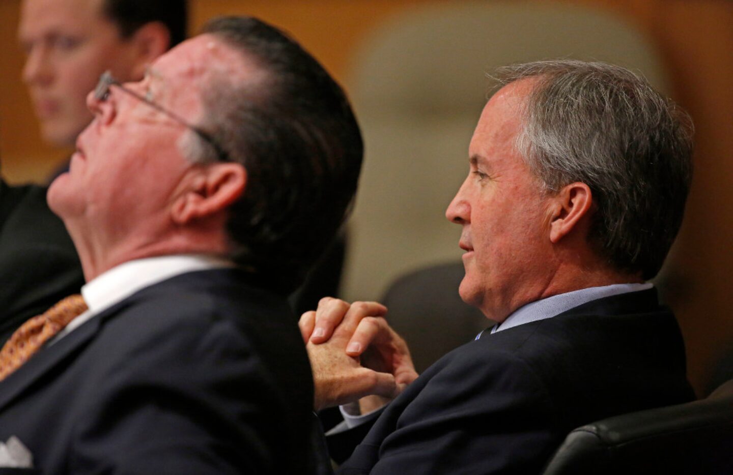 Texas Attorney General Ken Paxton (right) and his attorney Dan Cogdell sit at the defense...