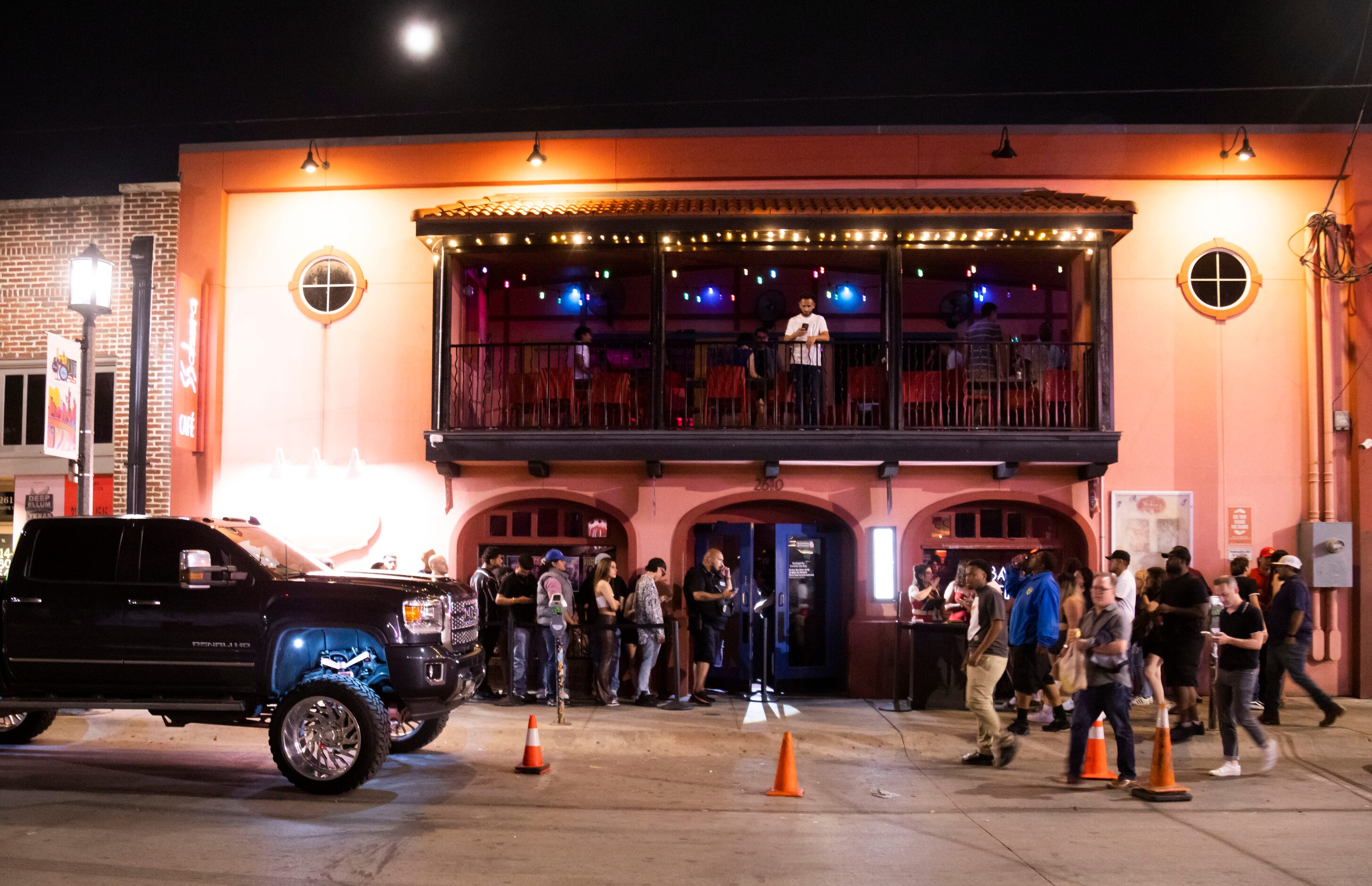 People wait in line to enter Cafe Salsera in the Deep Ellum district of Dallas on Saturday,...