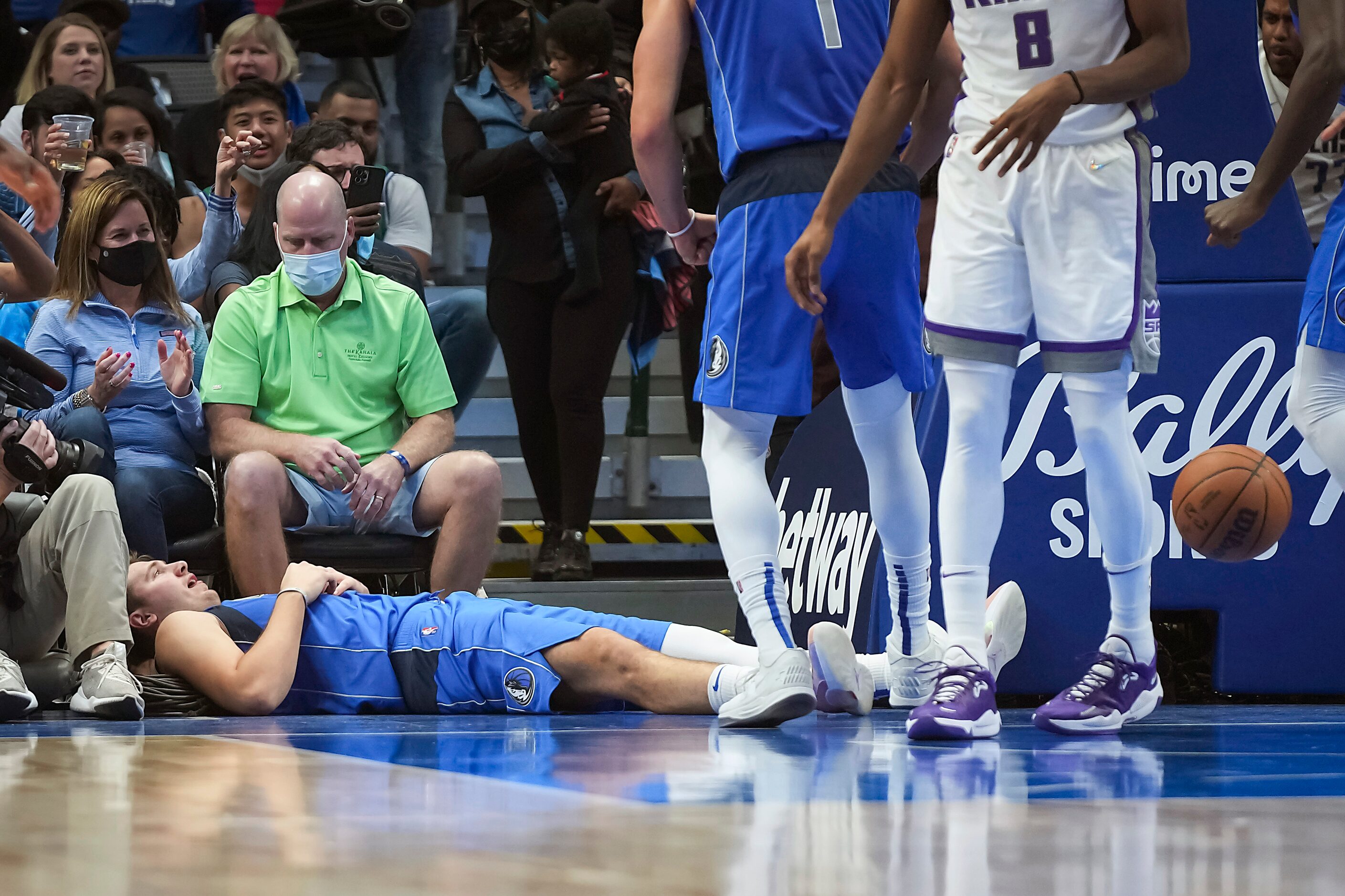 Dallas Mavericks guard Luka Doncic (77) falls to the baseline after being fouled on a drive...