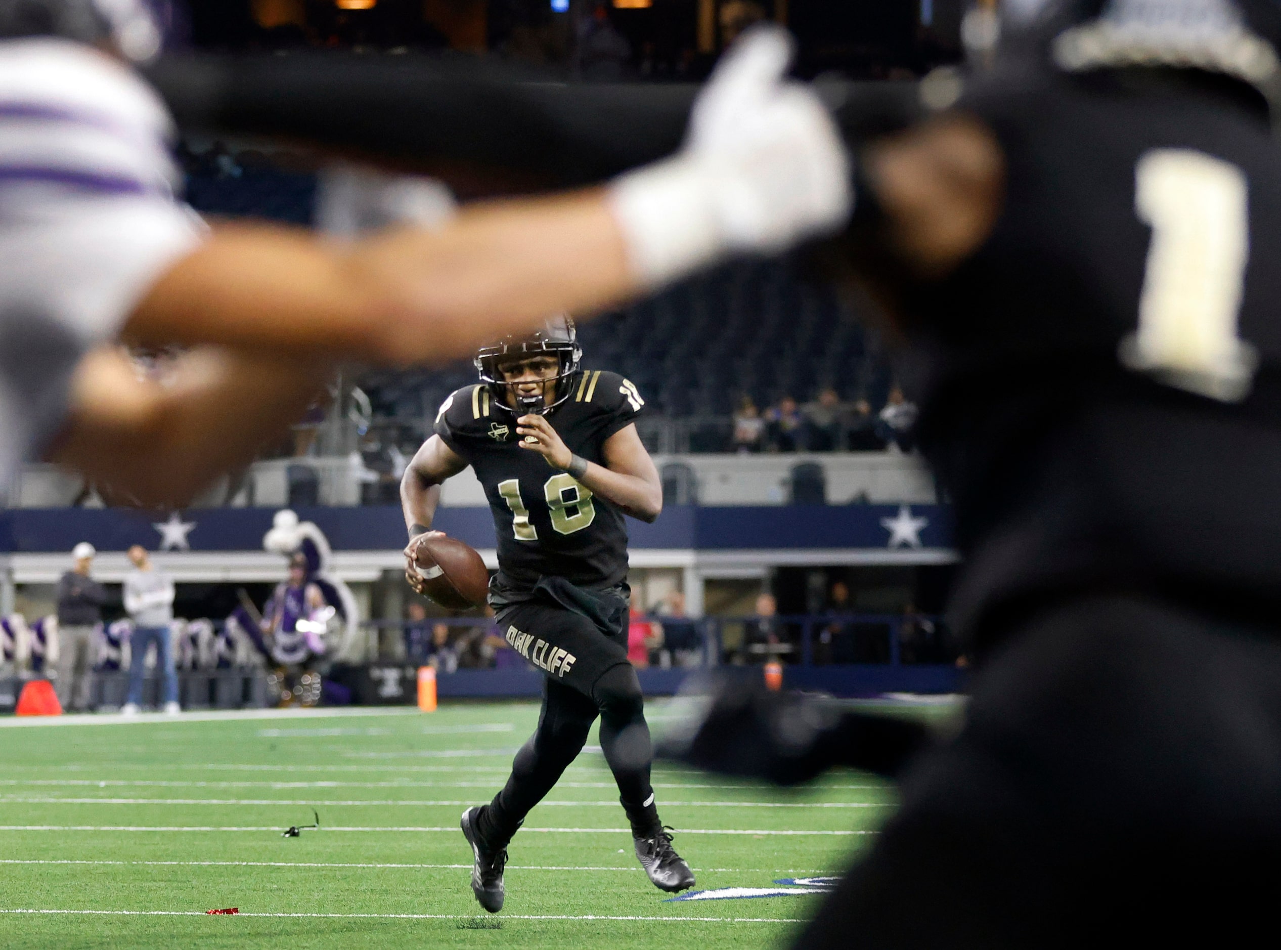 South Oak Cliff quarterback William Little (18) rolls out looking for a receiver during the...