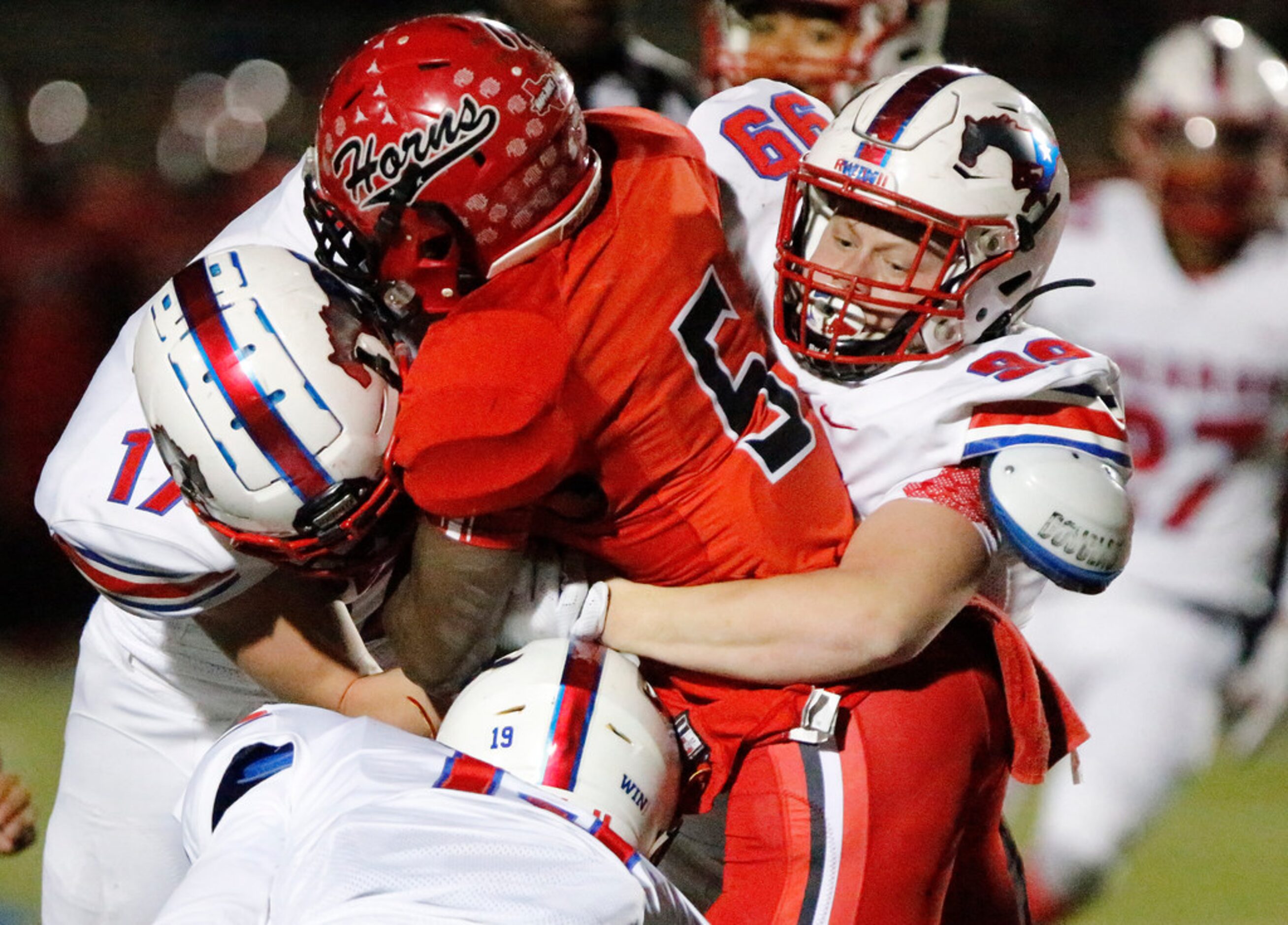 Pearce High School defensive lineman Nicky Pacione (99) leads team mates in tackling Cedar...