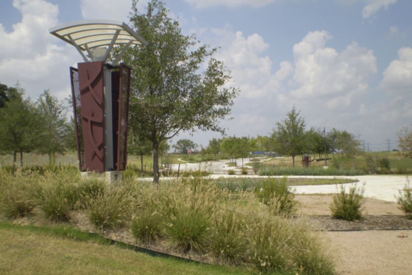 A traffic roundabout and landscaping form the entry to the vacant Midtown Park project on...