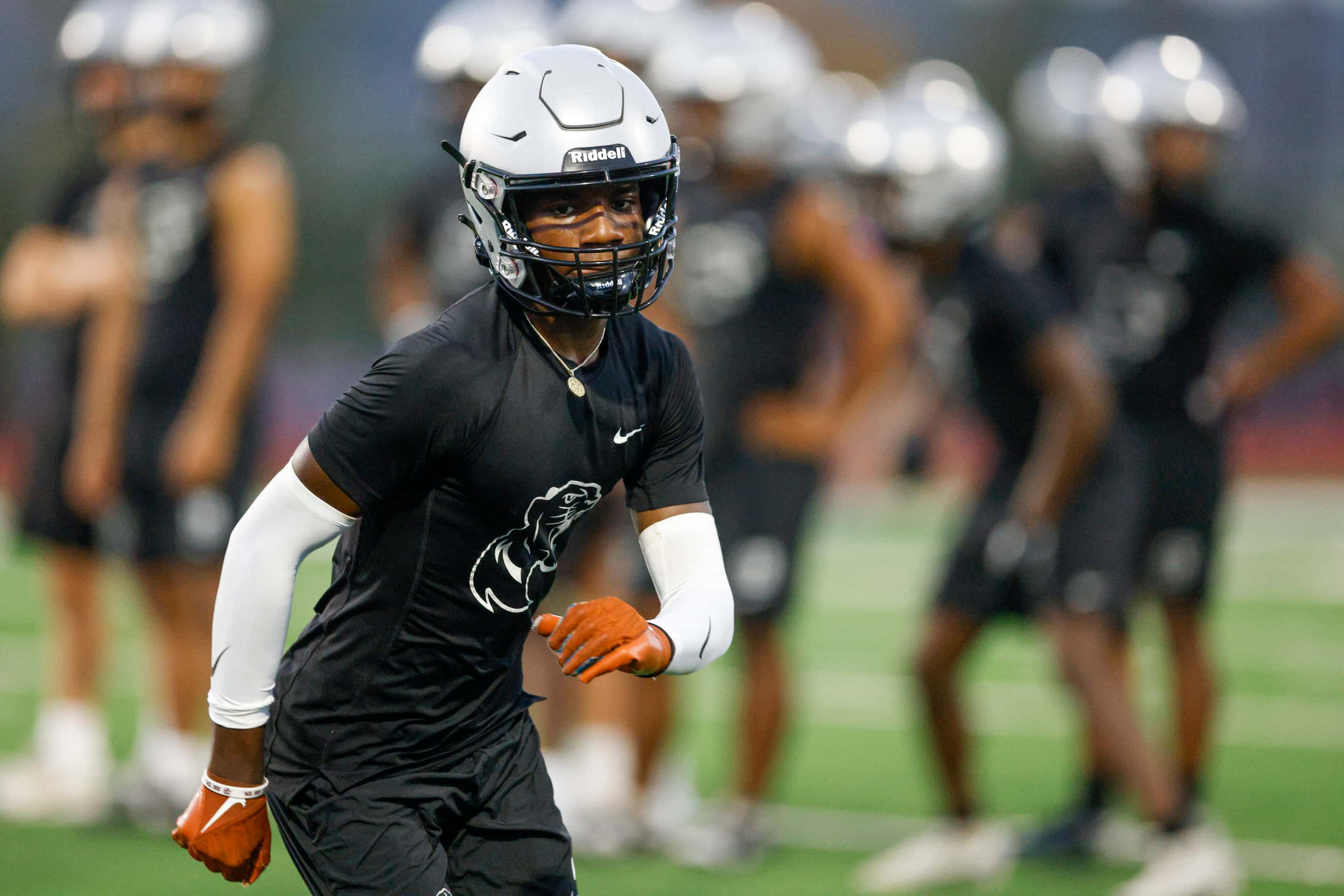 Wide receiver Jalen Lott runs a route during an early morning practice at Panther Creek High...