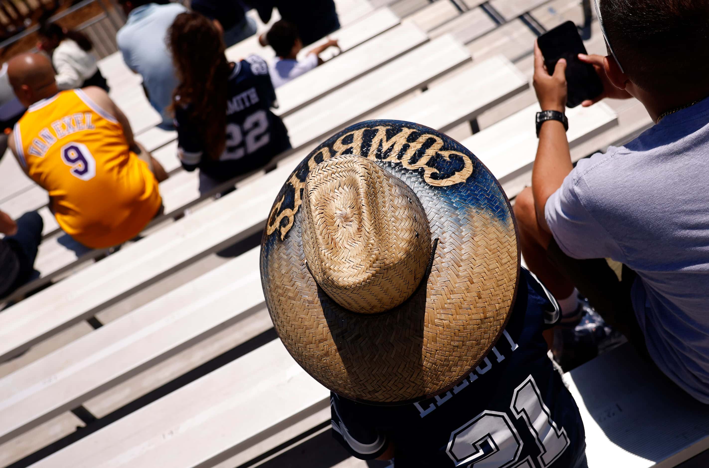 Dallas Cowboys fans watch training camp practice from the stands in Oxnard, California,...