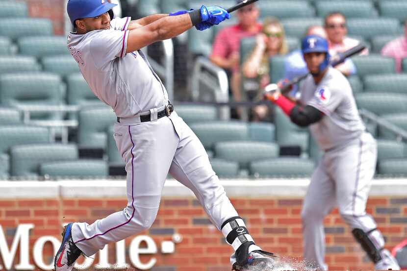 ATLANTA, GA - SEPTEMBER 6: Elvis Andrus #1 of the Texas Rangers hits a first inning solo...