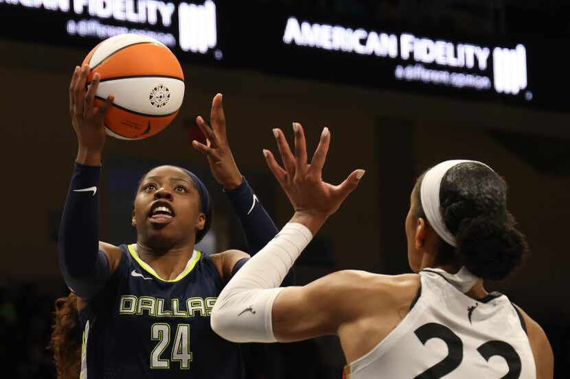 Dallas Wings guard Arike Ogunbowale (24) drives the lane to lay up for two of her first half...