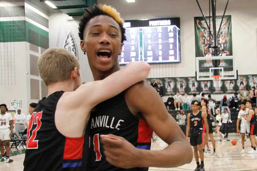 Duncanville's Ron Holland (right) celebrates after a victory over Waxahachie in the Class 6A...