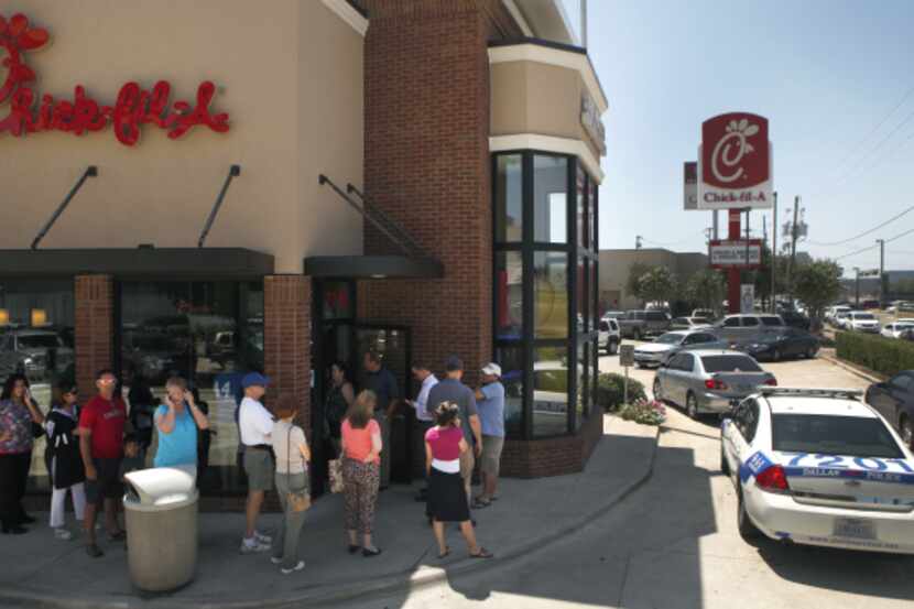 Chick-fil-a supporters waited in line outside the location at 7718 N. Central Expressway in...