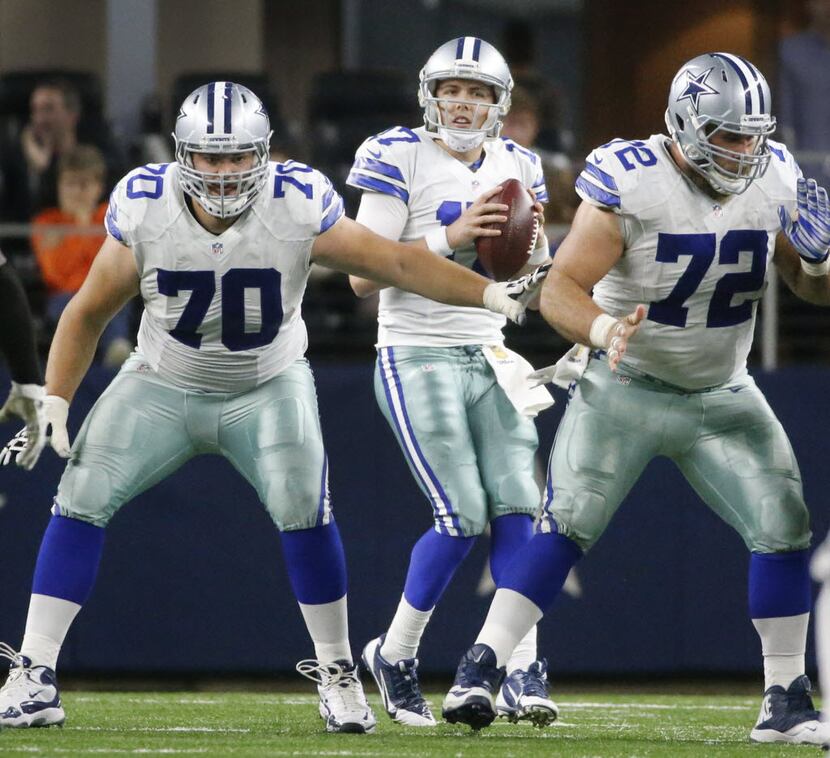 Dallas Cowboys quarterback Kellen Moore (17) looks for a receiver behind the protection of...