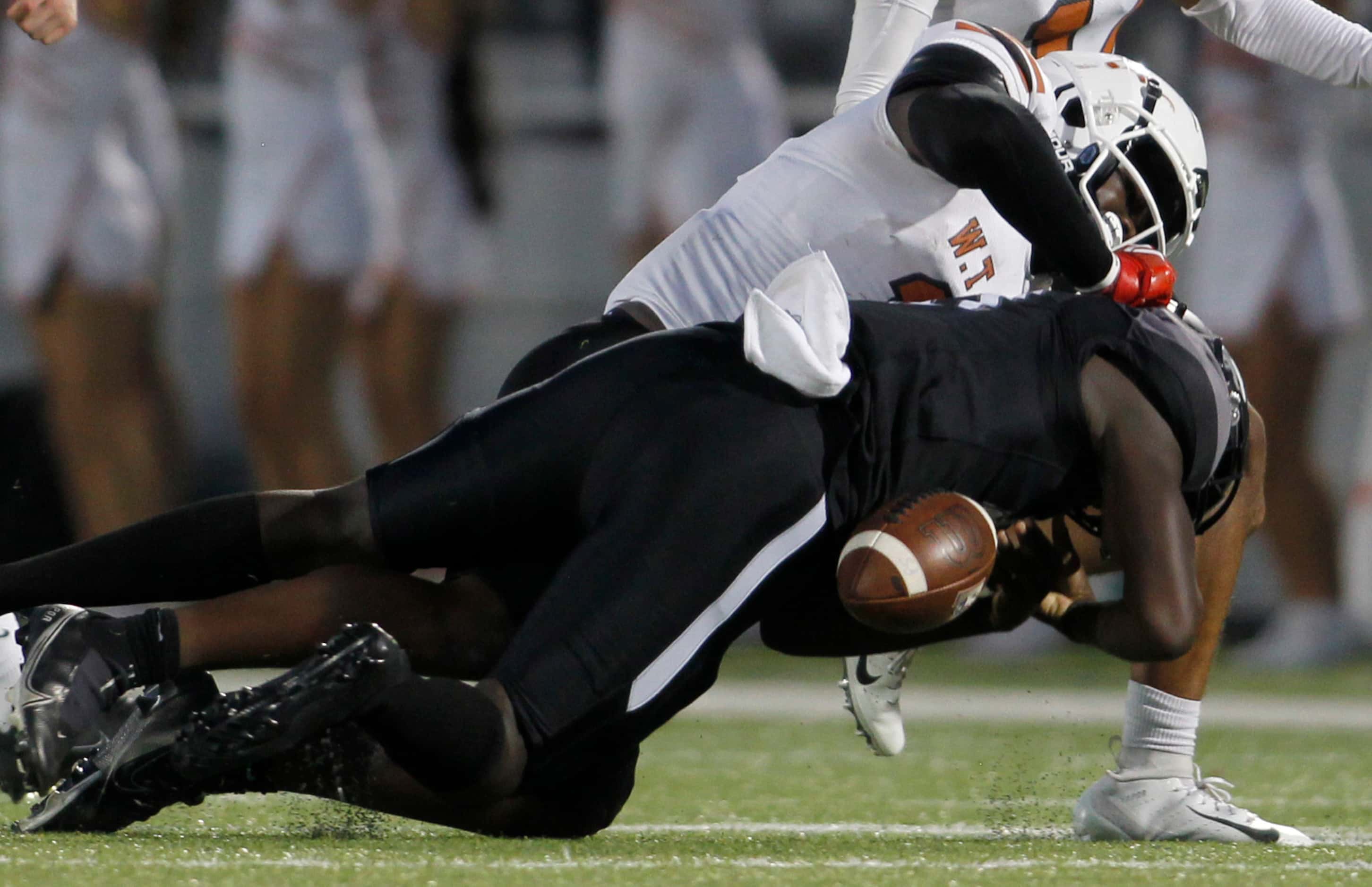 Mansfield Timberview quarterback Zuric Humes (17) loses the ball as he is tackled by W.T....