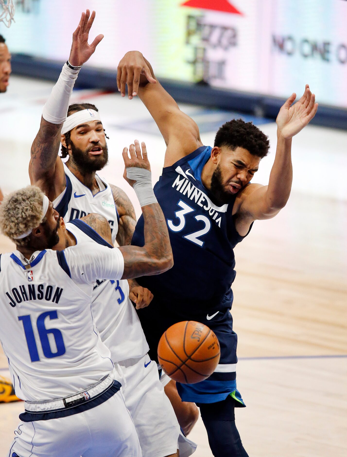 Dallas Mavericks guard Trey Burke (3) fouls Minnesota Timberwolves center Karl-Anthony Towns...