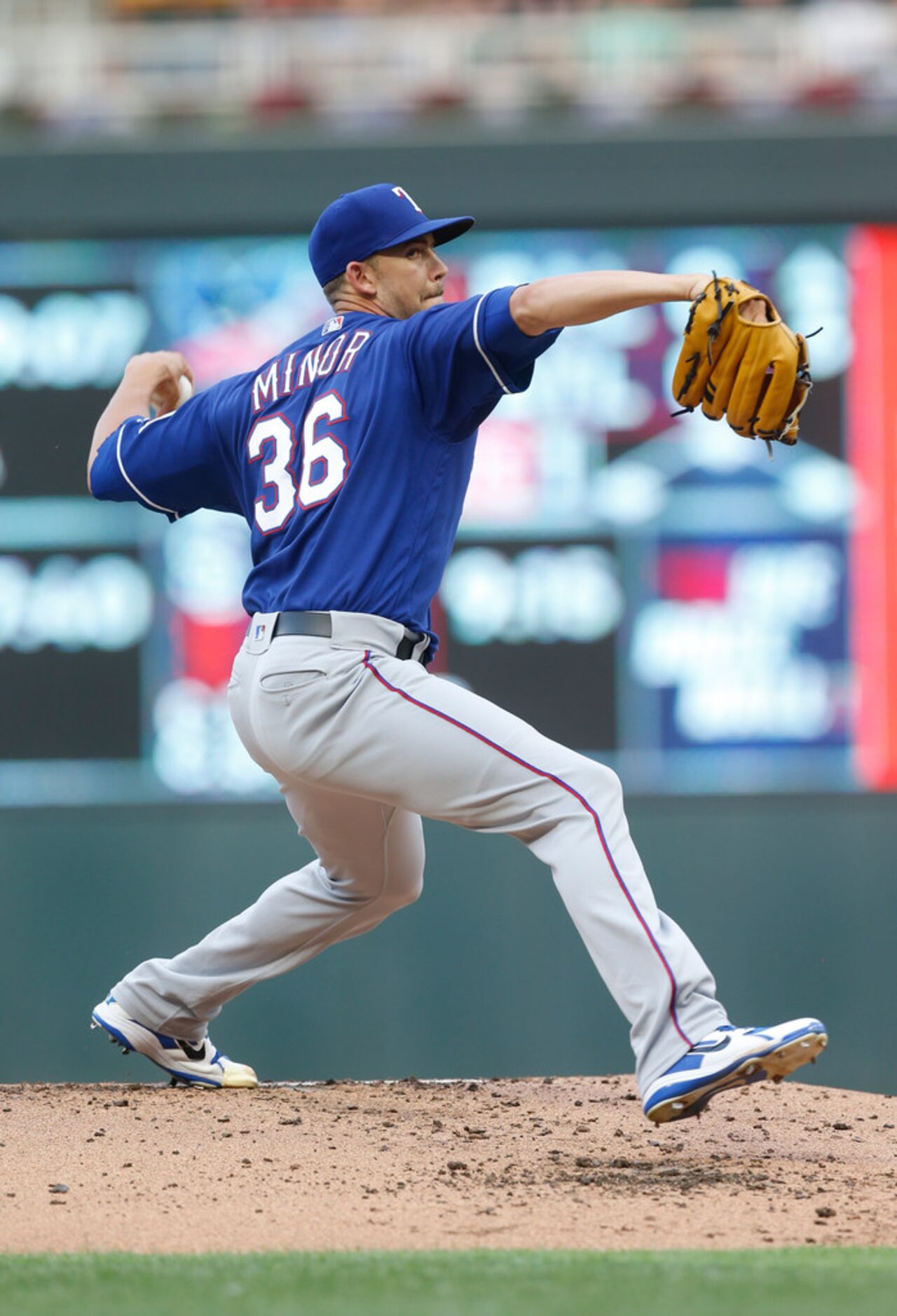 Texas Rangers' pitcher Mike Minor throws against the Minnesota Twins in the first inning of...