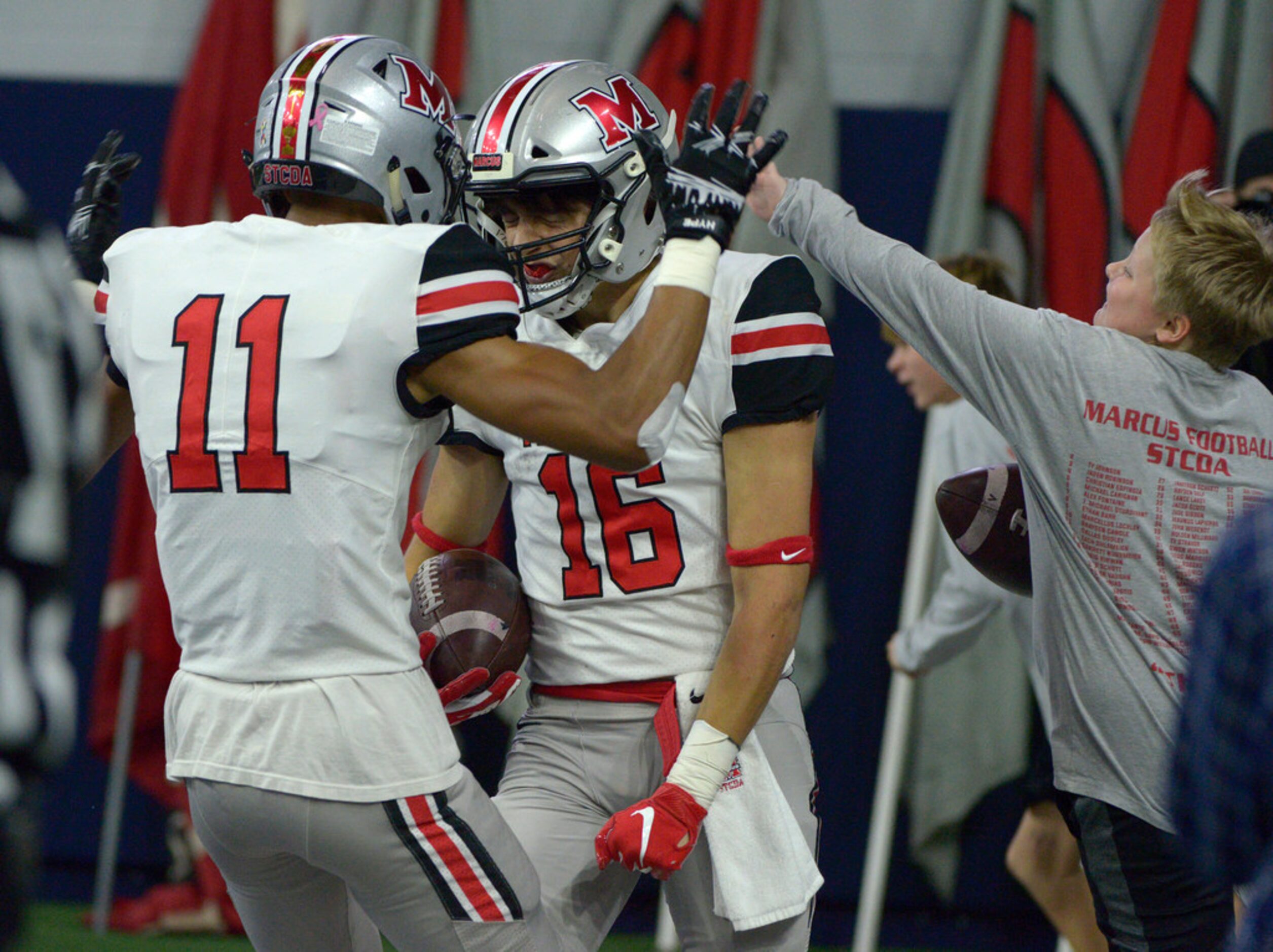 Flower Mound Marcus' Tyler Schott (16) celebrates his touchdown with Dallas Dudley (11) in...